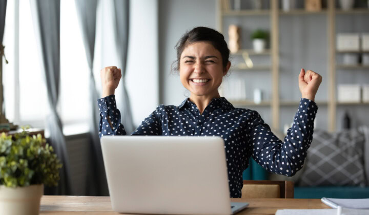 Euphoric young indian girl celebrate online victory triumph with laptop Our Benefits