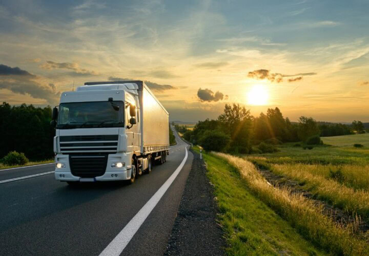 lorry using fleet telematics to drive on a road with the sun in the background
