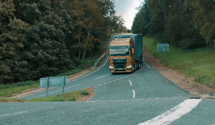 a lorry driving on a road with fleet vehicle telematics