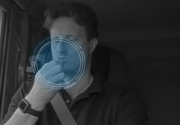 a man distracting himself whilst driving by smoking a cigarette