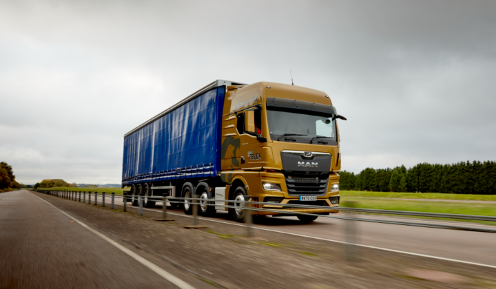 a lorry driving on the road using transport management system (TMS)