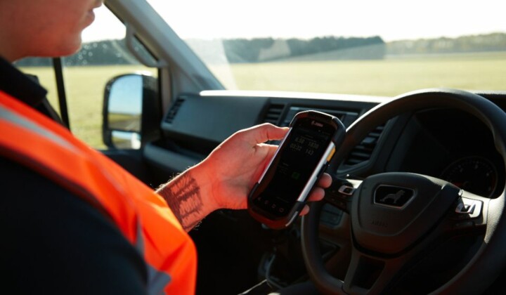 man using a zebra device linked to microlise transport managament system (tms)