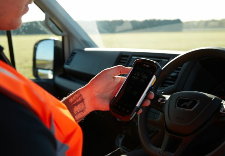 man using a zebra device linked to microlise transport managament system (tms)
