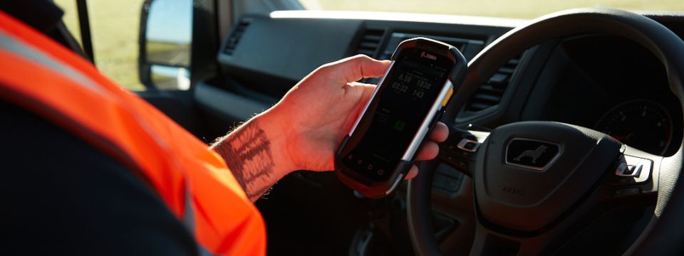 man using a zebra mobile device linked to microlise transport managament system (tms)