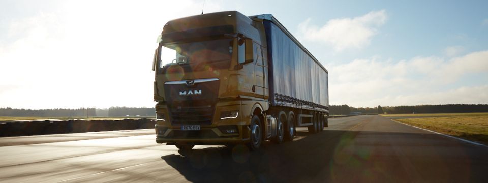 a MAN lorry driving on the road using transport management system (TMS)