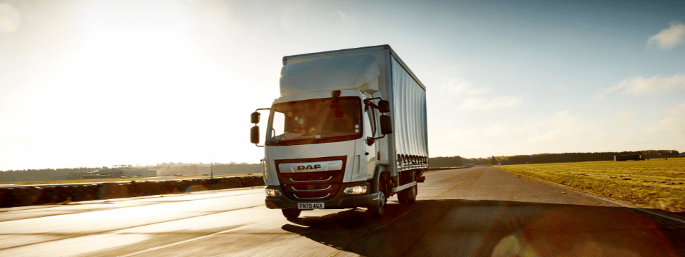 daf lorry driving on a quiet road using microlise transport management system (TMS)