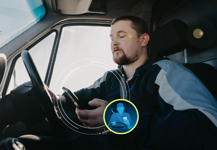 man using phone while driving