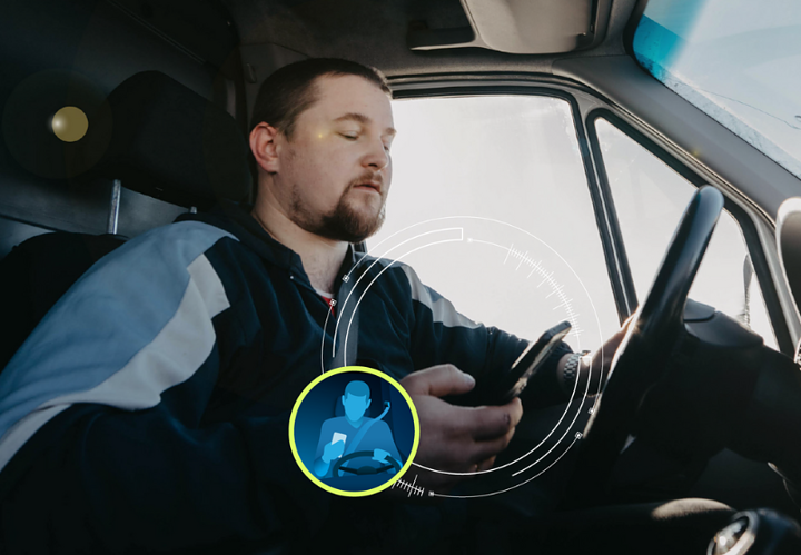 man-using-phone-while-driving-720x500
