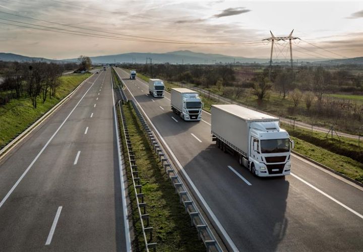 4 lorries driving on a road