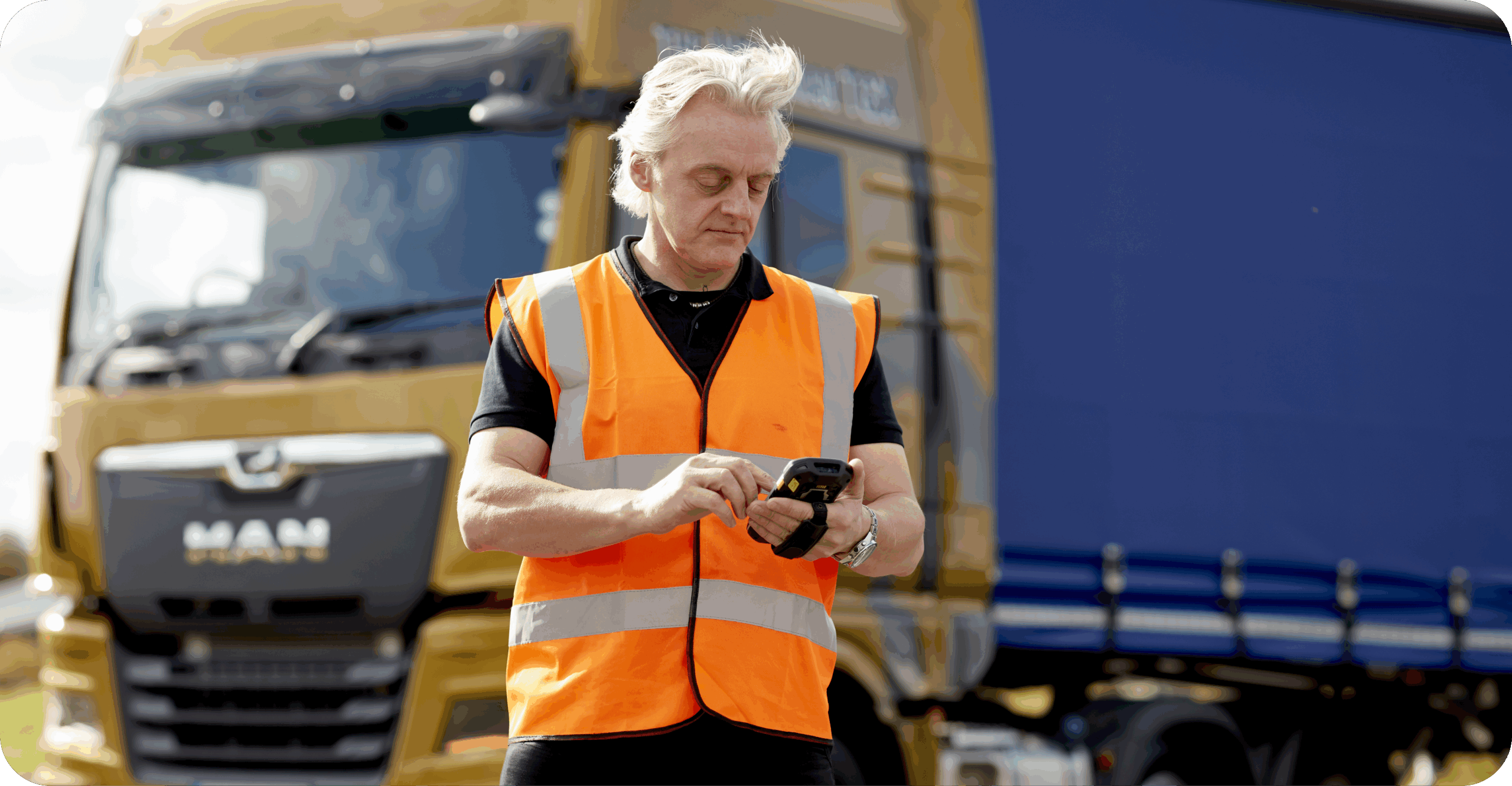 13-10-20 Microlise 1011 Android device showing logistics management software with trucks in the background, symbolising real-time fleet tracking and transport solutions from Microlise.