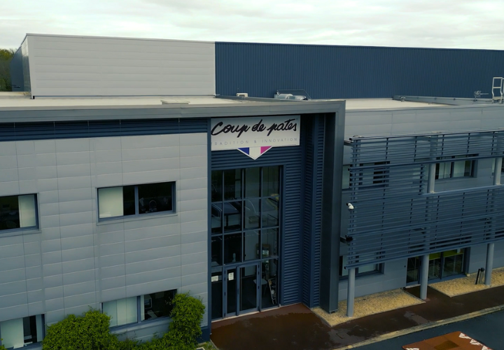 Microlise company headquarters building exterior with Coup de Pate signage, modern corporate office, logistics and fleet management innovation in UK.