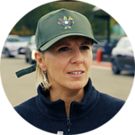 Advanced fleet management woman wearing a cap, outdoor parking lot, Microlise logistics solutions, transportation technology, driver safety, fleet optimisation, telematics, vehicle tracking, supply chain management, transportation software.
