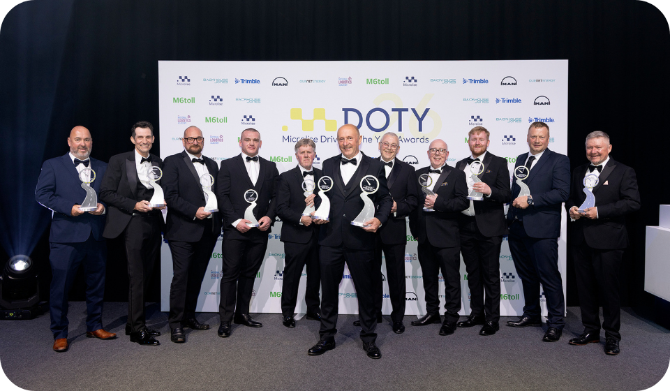 Microlise team receiving awards at a professional event, showcasing their industry recognition and commitment to excellence in transportation and logistics technology.
