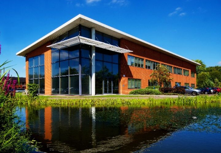 Modern Microlise office building with glass facade and surrounding greenery, celebrating the company's recent King’s Award for Enterprise 2026.